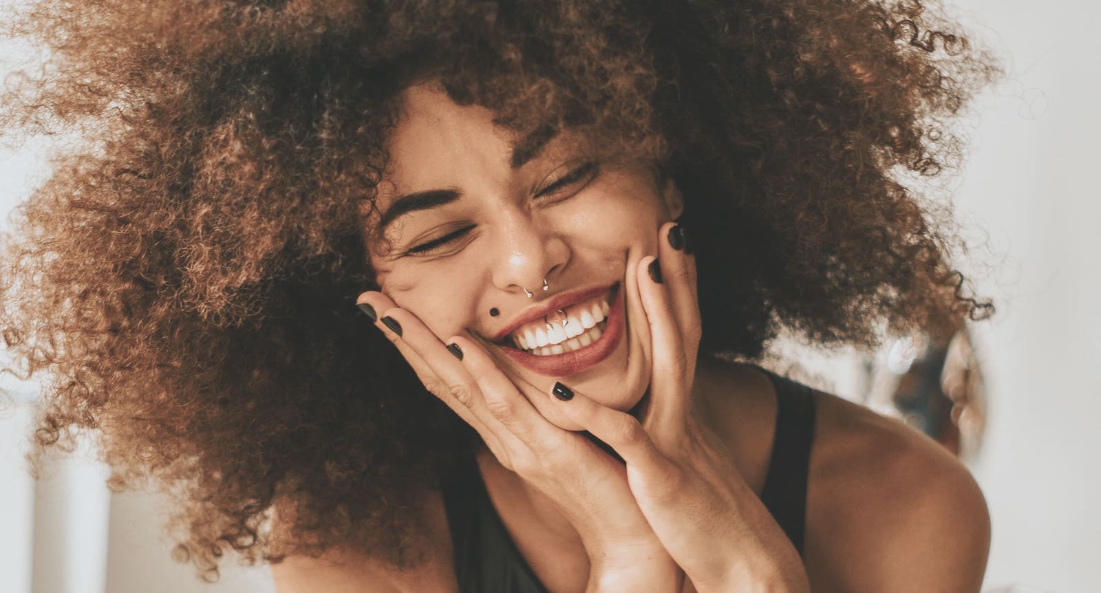 Happy woman with face piercings