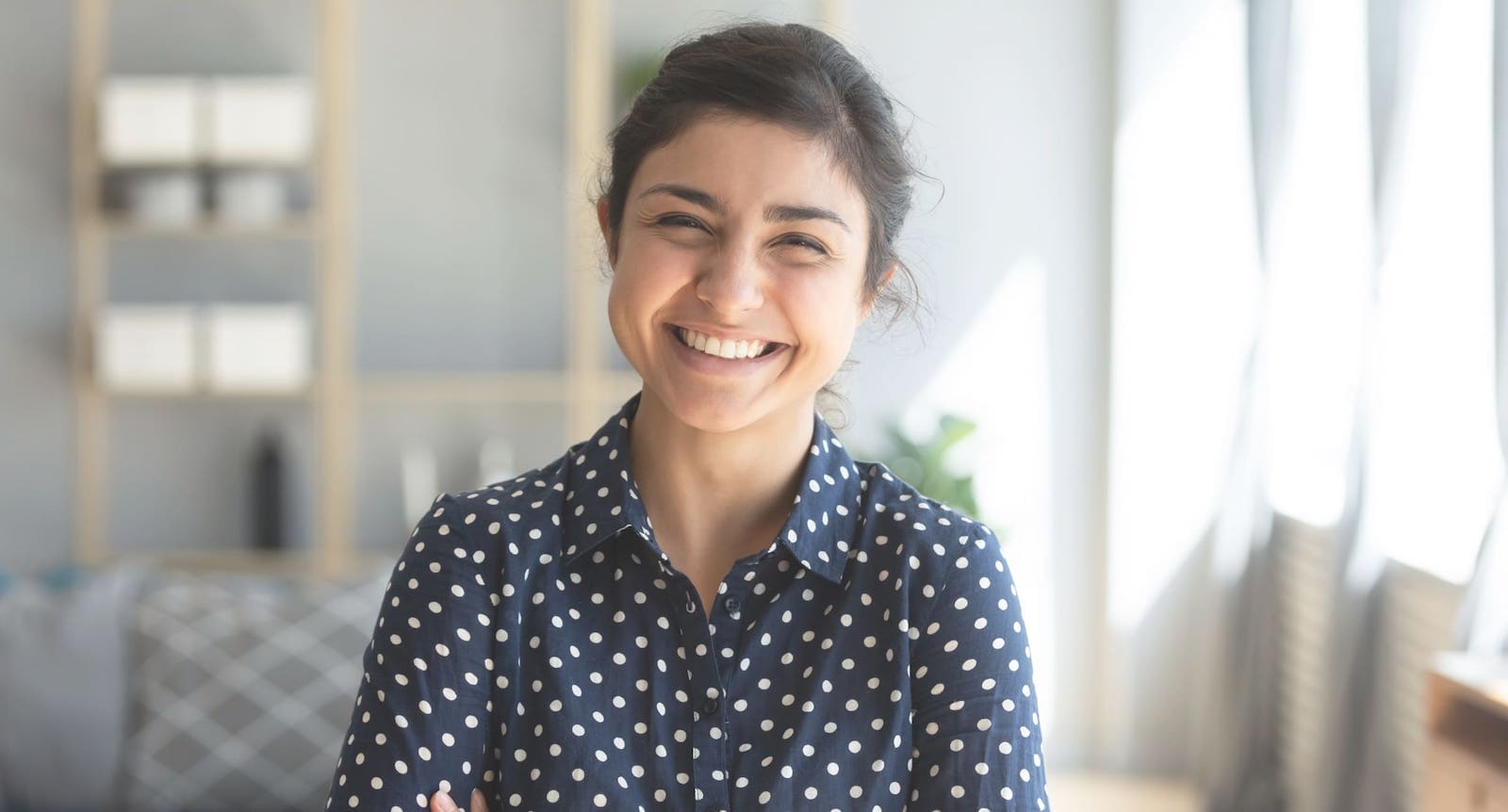 Cheerful woman in a polka dotted shirt