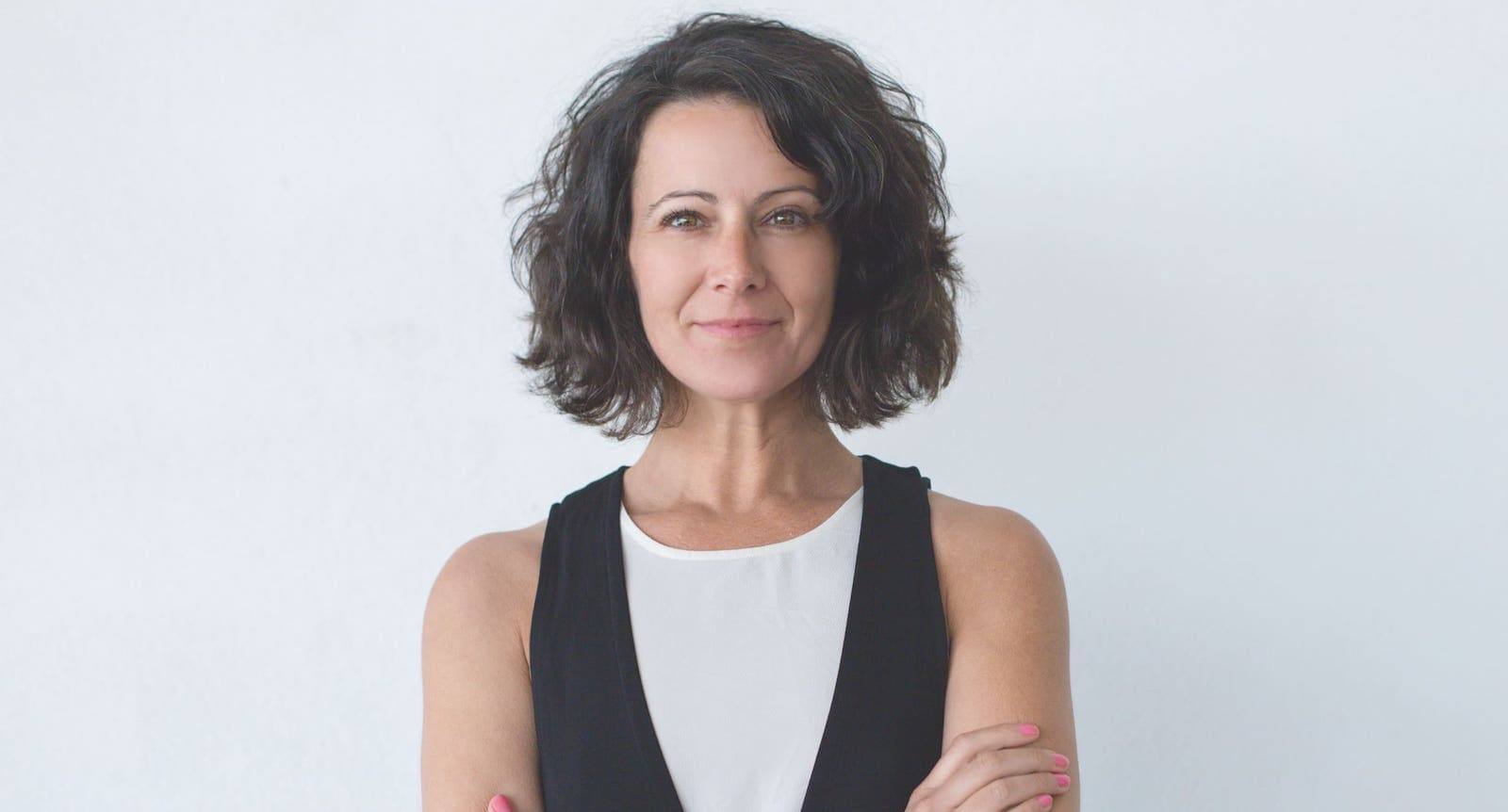 Middle-age woman in a black dress and white shirt