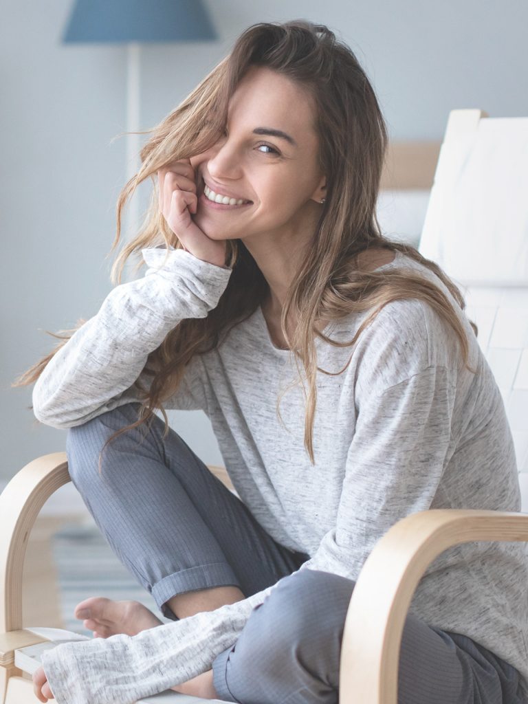 Smiling woman sitting in a chair