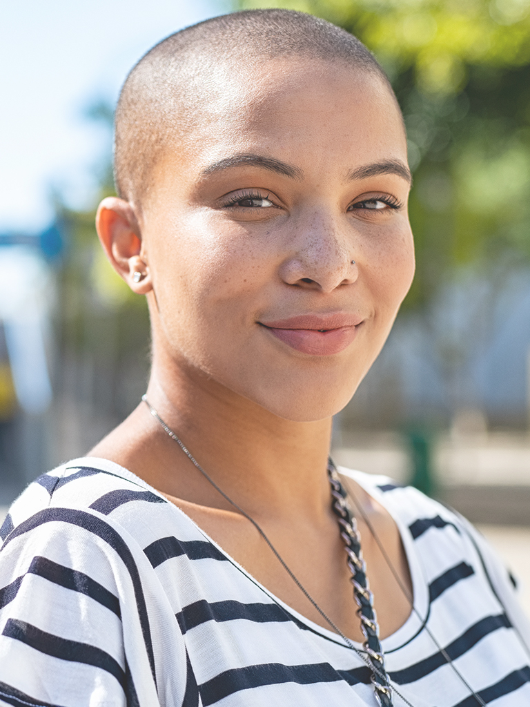 Smiling woman with a shaved head